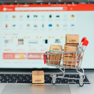 Boxes with a shopping cart on a laptop computer. online shopping, Marketplace platform website, technology, e-commerce, shipping delivery, logistics and online payment concepts